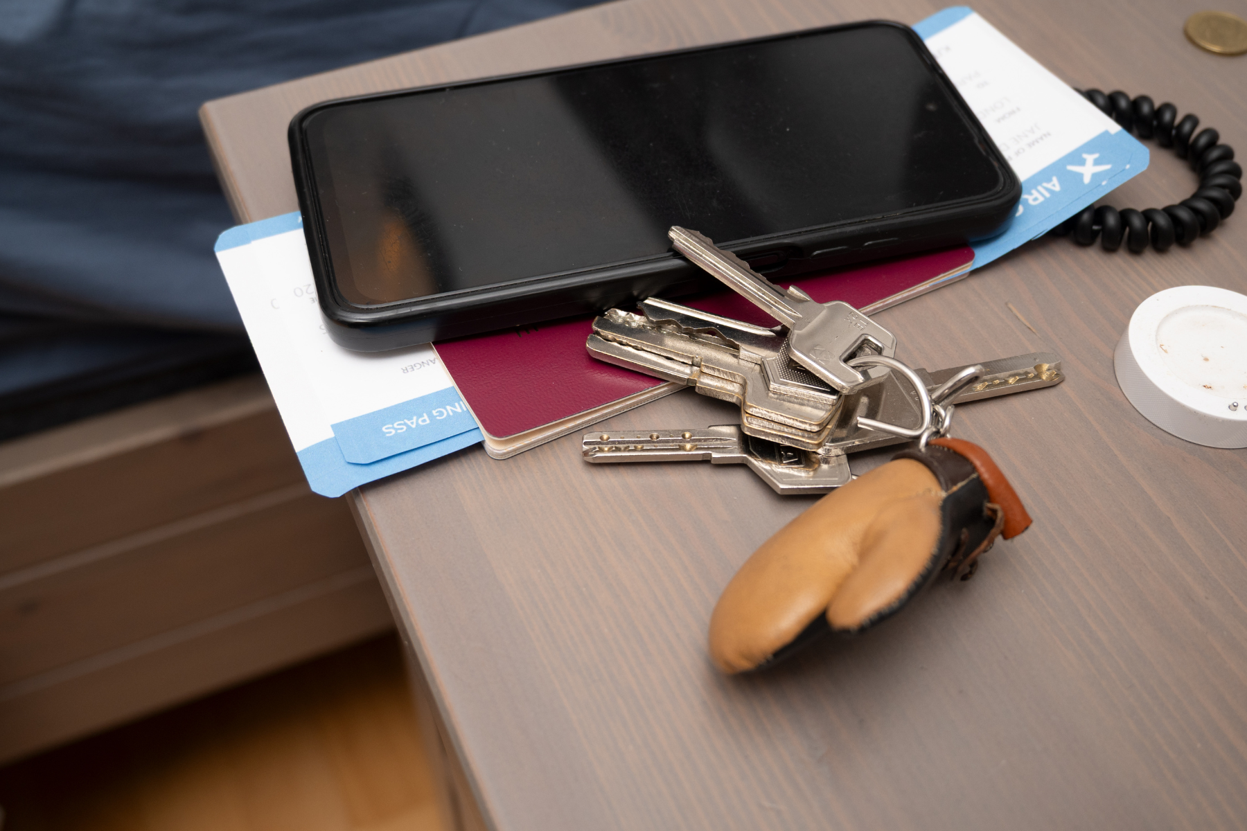 Keys, wallet, phone, and travel card on a table
